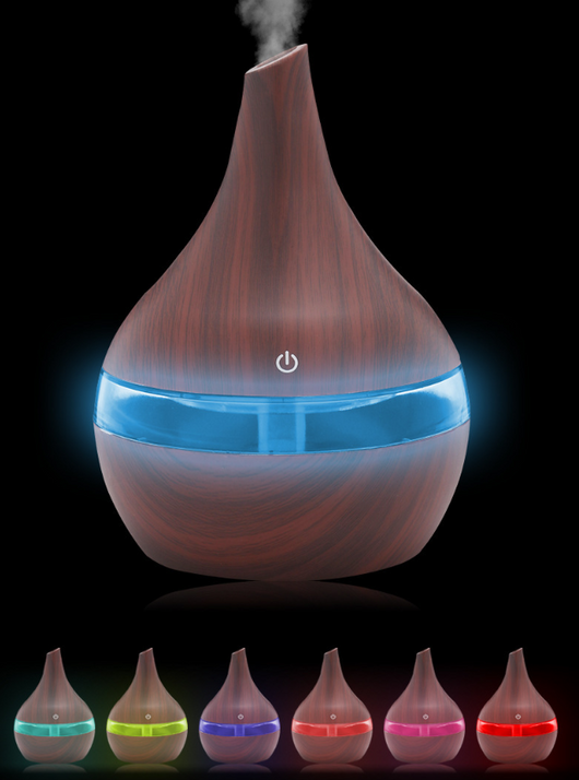 Teardrop-shaped humidifier with light wood grain finish and clear water tank, featuring a power button icon. - Image 4