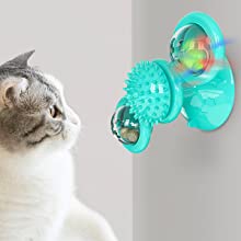 Gray tabby cat playing with a teal windmill cat toy featuring a suction cup base, textured ball, and colorful spinning paddles. - Image 11