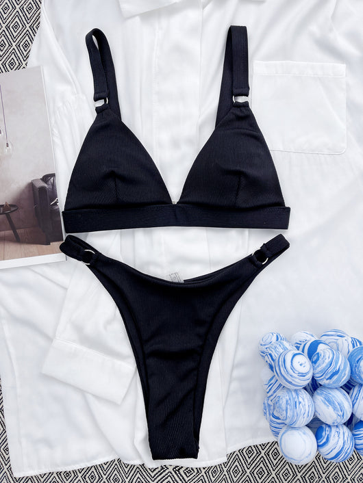 Coral ribbed two-piece bikini with triangle top and O-ring detail on straps and sides, worn by a woman. - Image 27