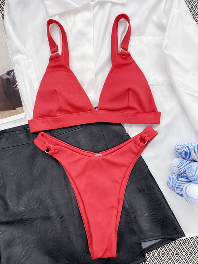 Coral ribbed two-piece bikini with triangle top and O-ring detail on straps and sides, worn by a woman. - Image 29
