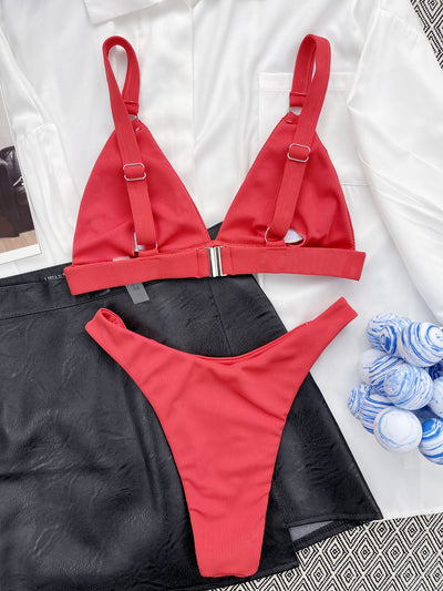 Coral ribbed two-piece bikini with triangle top and O-ring detail on straps and sides, worn by a woman. - Image 30