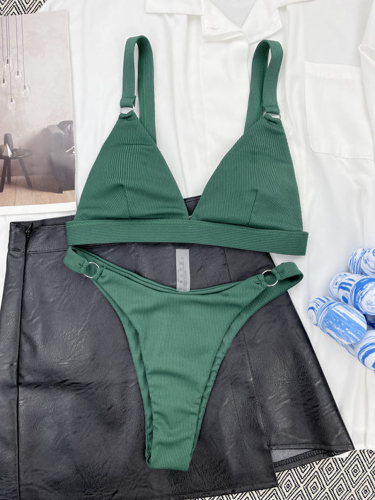 Coral ribbed two-piece bikini with triangle top and O-ring detail on straps and sides, worn by a woman. - Image 31