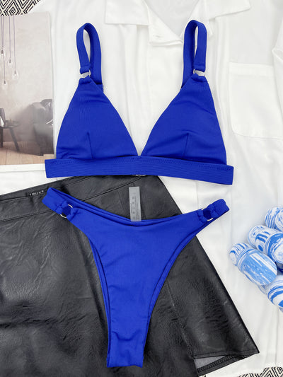 Coral ribbed two-piece bikini with triangle top and O-ring detail on straps and sides, worn by a woman. - Image 33