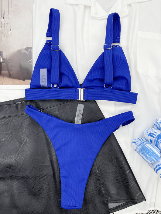 Coral ribbed two-piece bikini with triangle top and O-ring detail on straps and sides, worn by a woman. - Image 34