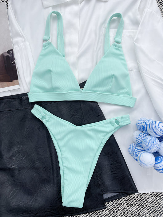 Coral ribbed two-piece bikini with triangle top and O-ring detail on straps and sides, worn by a woman. - Image 39