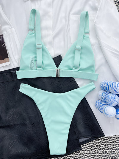 Coral ribbed two-piece bikini with triangle top and O-ring detail on straps and sides, worn by a woman. - Image 40