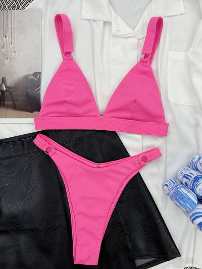 Coral ribbed two-piece bikini with triangle top and O-ring detail on straps and sides, worn by a woman. - Image 43