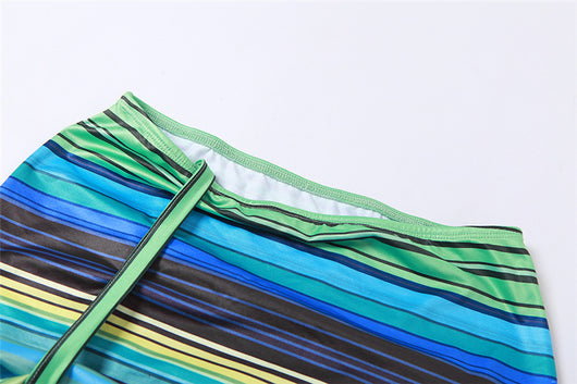 Women's green, blue, and yellow striped two-piece set with a V-neck crop top and an asymmetrical mini skirt. - Image 19