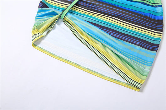 Women's green, blue, and yellow striped two-piece set with a V-neck crop top and an asymmetrical mini skirt. - Image 21