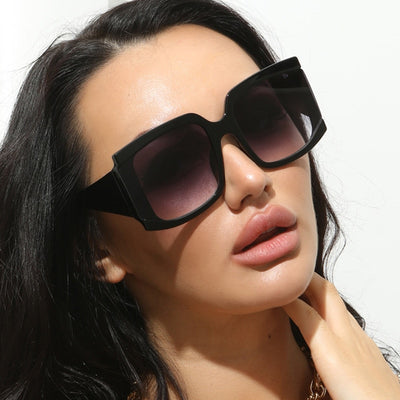 Oversized square-frame sunglasses with a light pink frame and gradient lenses transitioning from purple to orange to yellow. - Image 11