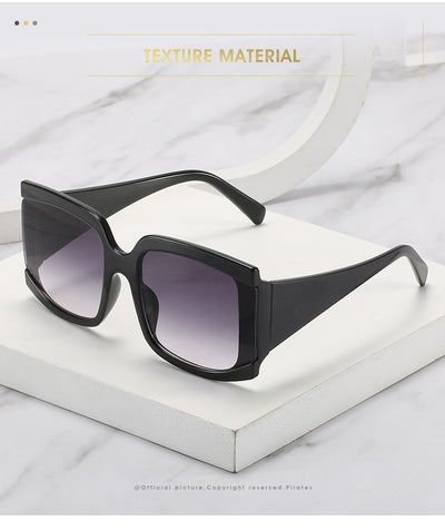 Oversized square-frame sunglasses with a light pink frame and gradient lenses transitioning from purple to orange to yellow. - Image 15