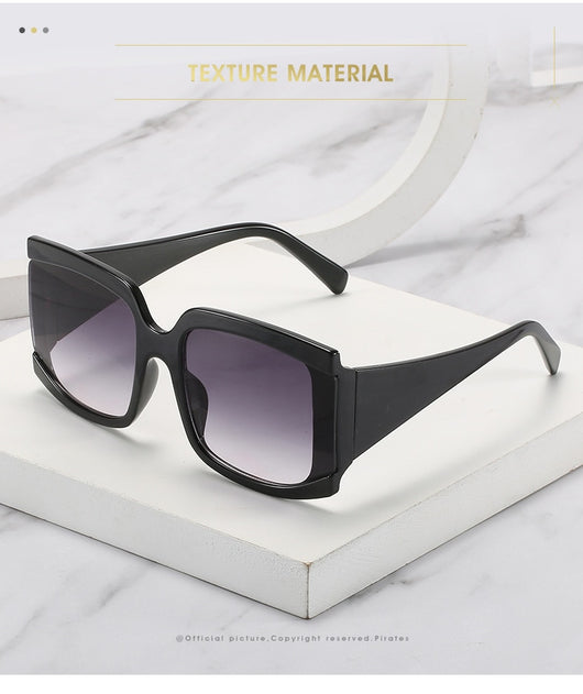 Oversized square-frame sunglasses with a light pink frame and gradient lenses transitioning from purple to orange to yellow. - Image 15
