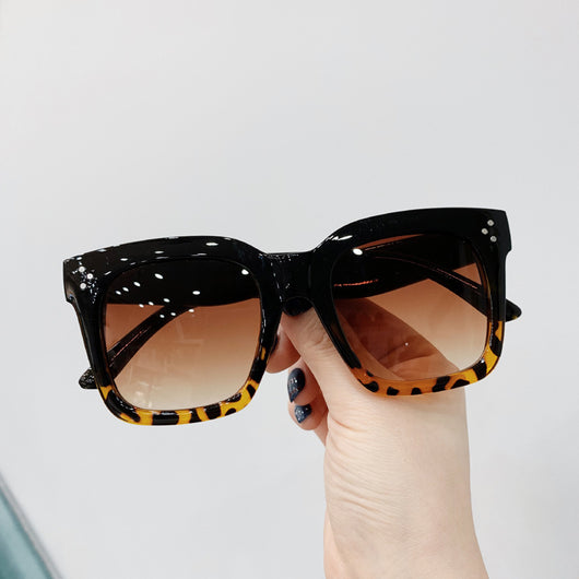 Retro oversized square sunglasses with a dark red frame and pink gradient lenses, held by a hand. - Image 6