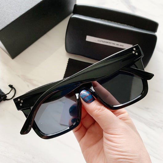Retro oversized square sunglasses with a dark red frame and pink gradient lenses, held by a hand. - Image 9