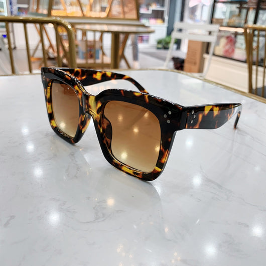 Retro oversized square sunglasses with a dark red frame and pink gradient lenses, held by a hand. - Image 10
