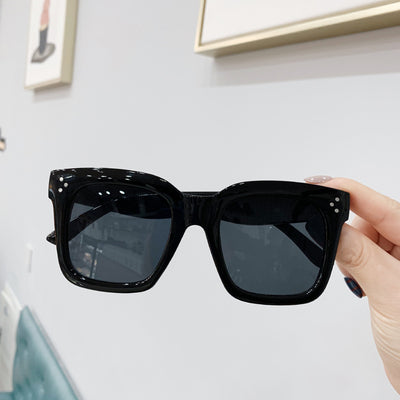 Retro oversized square sunglasses with a dark red frame and pink gradient lenses, held by a hand. - Image 13
