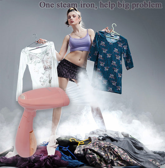 Pink handheld garment steamer with a clear water tank, silver soleplate, and a detachable brush attachment. - Image 9
