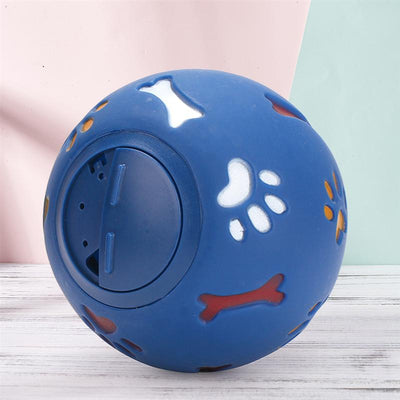 Red rubber pet puzzle ball with white, blue, and orange paw print and bone cutouts, featuring a treat dispenser opening. - Image 9