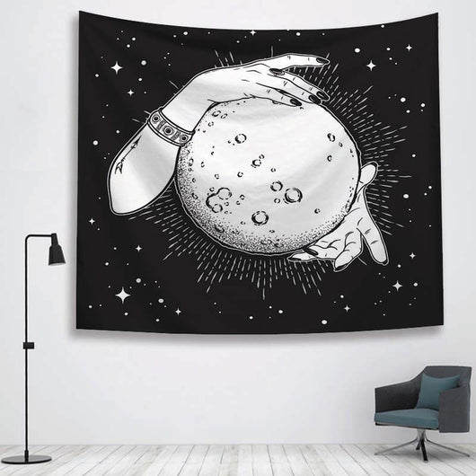 Black and white tapestry featuring two hands holding a full moon against a starry night sky, hanging on a white wall. - Image 3