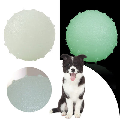 Interactive pet glow ball, off-white in daylight and glowing green in the evening, with a textured surface. - Image 7