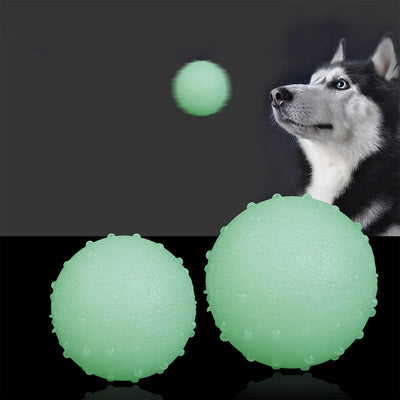 Interactive pet glow ball, off-white in daylight and glowing green in the evening, with a textured surface. - Image 8
