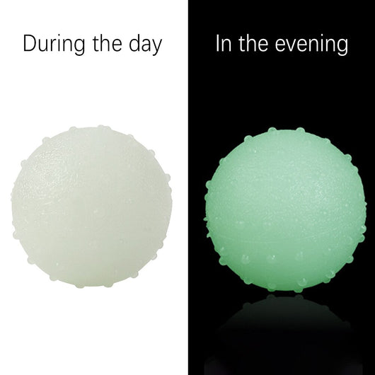 Interactive pet glow ball, off-white in daylight and glowing green in the evening, with a textured surface. - Image 9