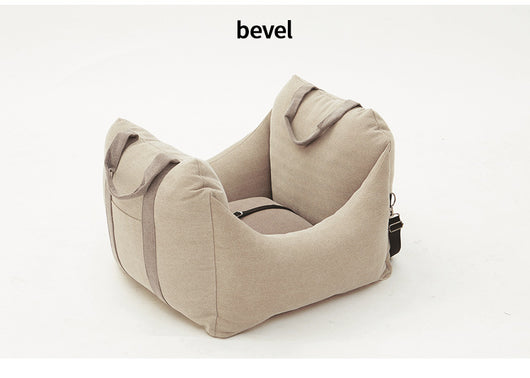 Beige pet car carrier seat with tan straps and a separate red pet seatbelt leash for safe car travel. - Image 24