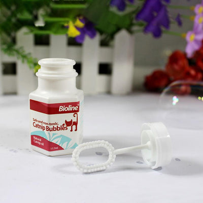 Bioline Catnip Bubbles bottle with a red label, featuring a cat silhouette and text "Safe and non-toxic. Natural Catnip oil 17.7ml". A white bubble wand is next - Image 13