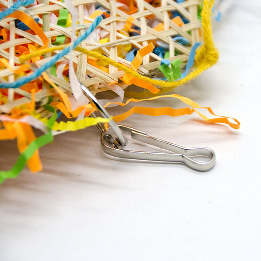 Colorful bird toy made from woven straw, filled with shredded paper, with a red star and hanging hook. - Image 12