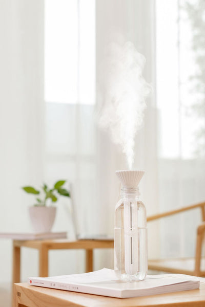 Beige and white USB ultrasonic humidifier with a fluted conical top and a cylindrical body with a water level window. - Image 13