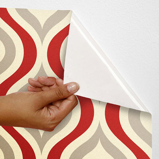 Red, beige, and grey retro wavy pattern self-adhesive wallpaper roll partially unrolled on a light grey wall. - Image 23