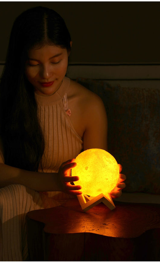 Moon-shaped night light and air humidifier on a wooden stand, emitting mist and a warm glow, with books and flowers. - Image 18