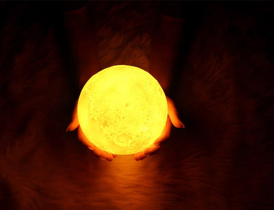 Moon-shaped night light and air humidifier on a wooden stand, emitting mist and a warm glow, with books and flowers. - Image 27