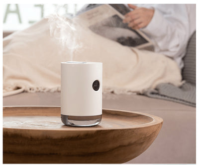 White cylindrical humidifier with a transparent base, digital display, and 1000ml capacity indicator. - Image 16