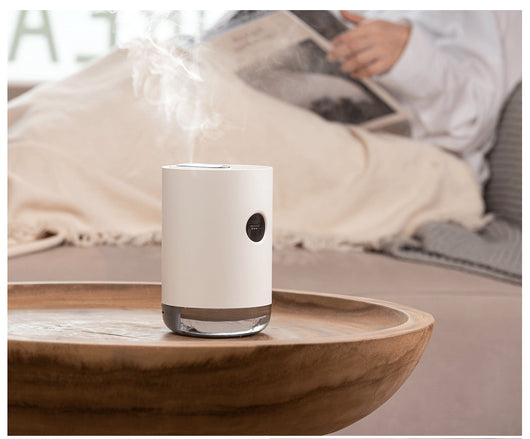 White cylindrical humidifier with a transparent base, digital display, and 1000ml capacity indicator. - Image 16