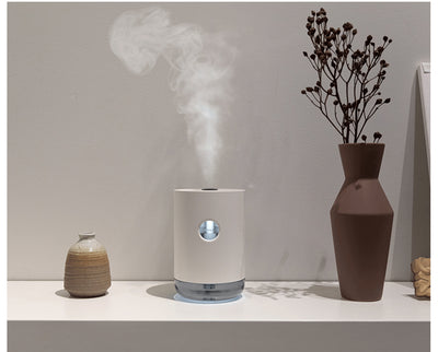White cylindrical humidifier with a transparent base, digital display, and 1000ml capacity indicator. - Image 18