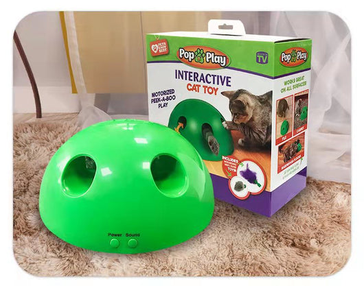 A cute tabby and white kitten with green eyes playing with a bright green dome-shaped interactive cat toy. - Image 14