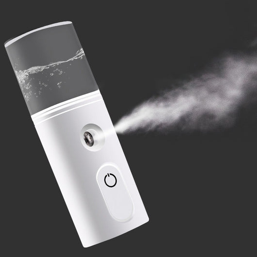 White portable facial humidifier with a clear water tank and a power button, for on-the-go moisturizing. - Image 10