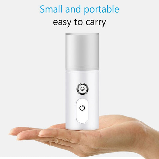 White portable facial humidifier with a clear water tank and a power button, for on-the-go moisturizing. - Image 13