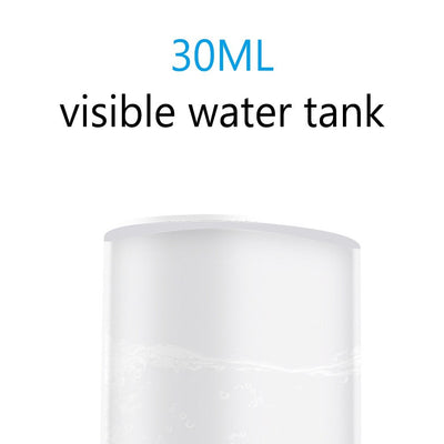 White portable facial humidifier with a clear water tank and a power button, for on-the-go moisturizing. - Image 14