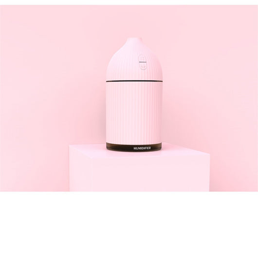 Pink ribbed aromatherapy diffuser and ultrasonic humidifier with a transparent brown base and control buttons. - Image 14