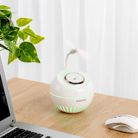 Dark green spherical humidifier with a textured top, control icons, and "HUMIDIFIER" printed on its side. - Image 12