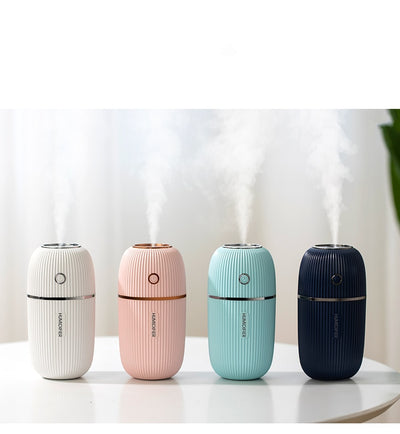 Navy blue portable humidifier with a ribbed texture, silver accents, and a power button on a white background. - Image 7