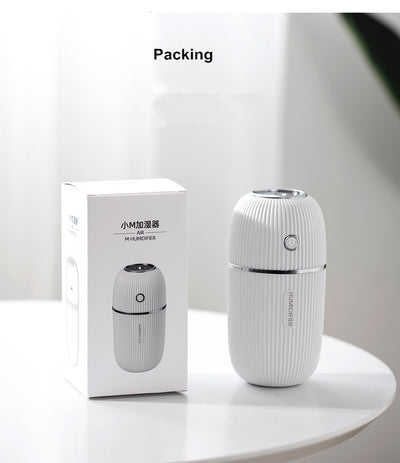 Navy blue portable humidifier with a ribbed texture, silver accents, and a power button on a white background. - Image 11