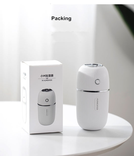 Navy blue portable humidifier with a ribbed texture, silver accents, and a power button on a white background. - Image 11