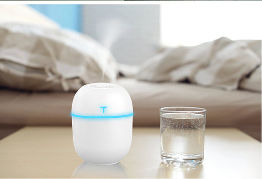 Teal egg-shaped USB humidifier with a glowing blue light band and a 'T' shaped indicator on top. - Image 4