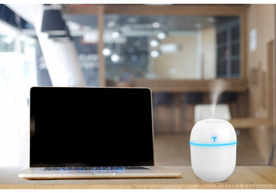 Teal egg-shaped USB humidifier with a glowing blue light band and a 'T' shaped indicator on top. - Image 5