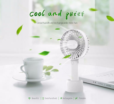 White ORICO FH1 handheld USB fan with charging dock, USB cable, and user manuals on a wooden desk. - Image 8