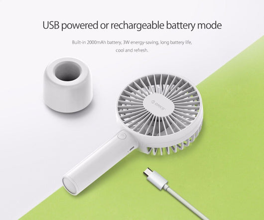 White ORICO FH1 handheld USB fan with charging dock, USB cable, and user manuals on a wooden desk. - Image 10