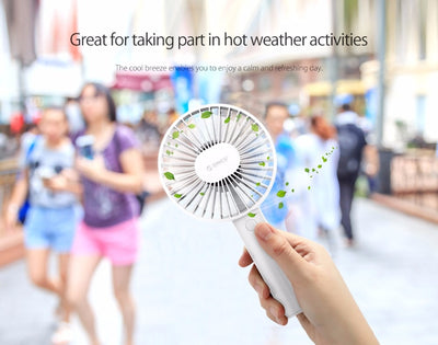 White ORICO FH1 handheld USB fan with charging dock, USB cable, and user manuals on a wooden desk. - Image 13